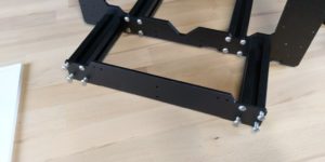 Attach front and back plates with the M5x16 screws. Make sure the frame still sits flat on the extrusions and tighten the screws fully.